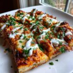 Close-up of sliced Buffalo Chicken Flatbread Pizza topped with melted cheese, sauce, ranch drizzle, and fresh parsley.