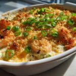 Close-up of baked Hot Shrimp Jalapeno Popper Dip topped with golden breadcrumbs and green onions.