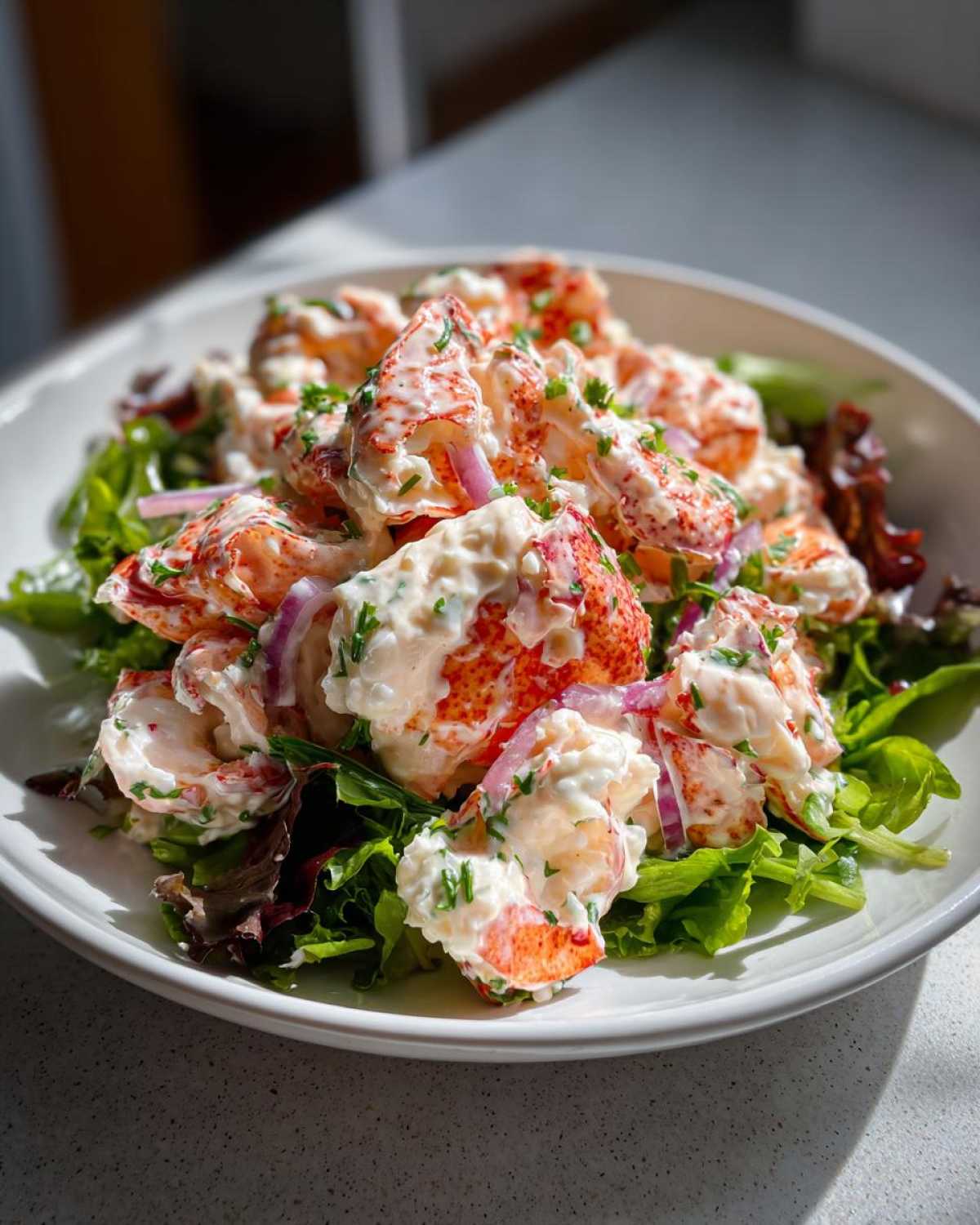 Generous chunks of lobster tail mixed in creamy lemon mayo dressing served over mixed greens for Lobster Tail Salad.