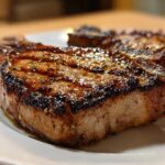 Close-up of a perfectly grilled, glazed pork chop showing char marks, made with the best marinade for pork chops.