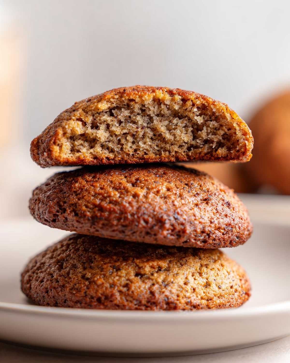 Close-up of three stacked breakfast cookie halves, showing the soft, moist interior texture of the top cookie.