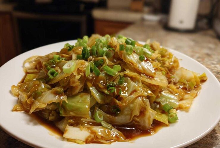 A close-up of a serving of Cabbage Stir Fry with Garlic Ginger Sauce, topped with fresh green onions.