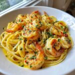Close-up of delicious Creamy Lemon Garlic Shrimp Pasta topped with parsley and chili flakes.