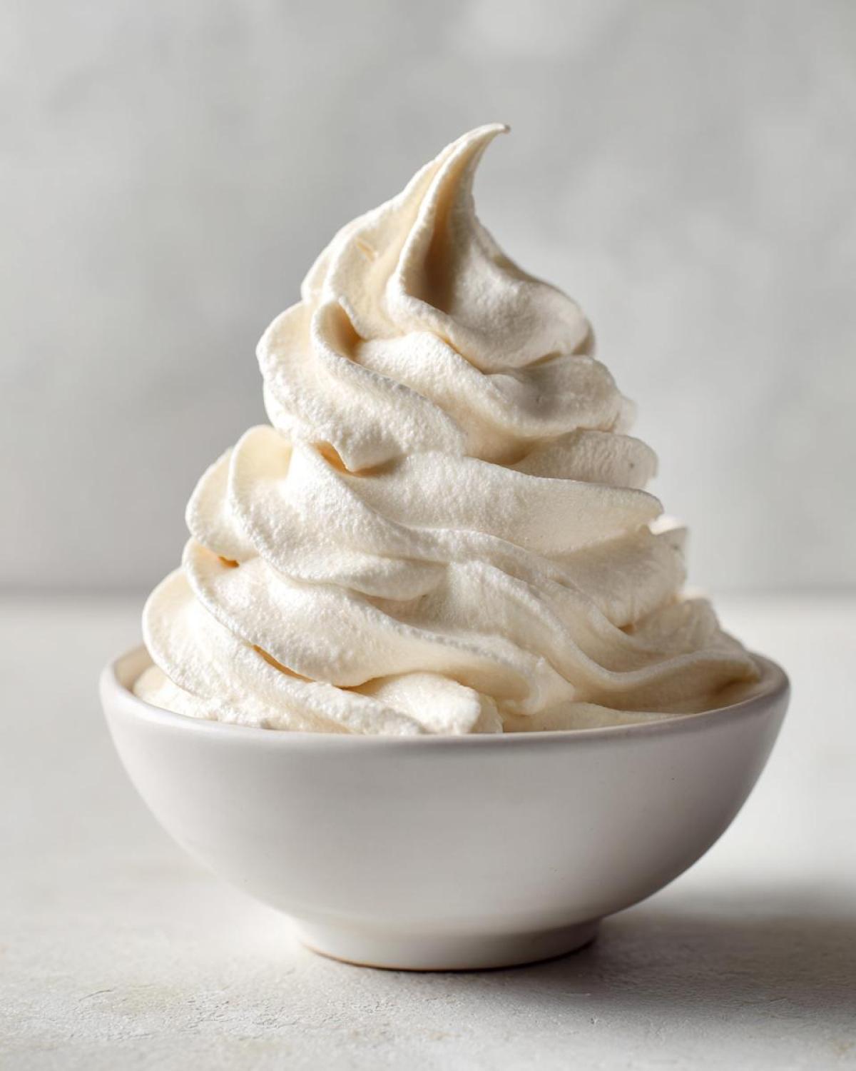Close-up of a thick, soft-serve swirl of Creamy Vanilla Protein Smoothie Bowl in a white bowl.