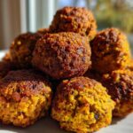 A close-up stack of golden-brown, crispy air fryer falafel balls showing their textured exterior.