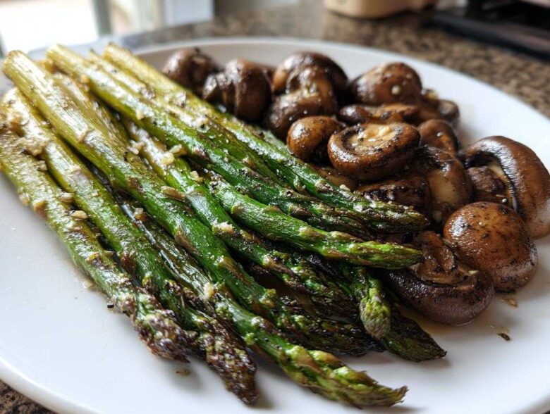 A plate featuring vibrant green Garlic Butter Roasted Asparagus and browned, savory roasted mushrooms.