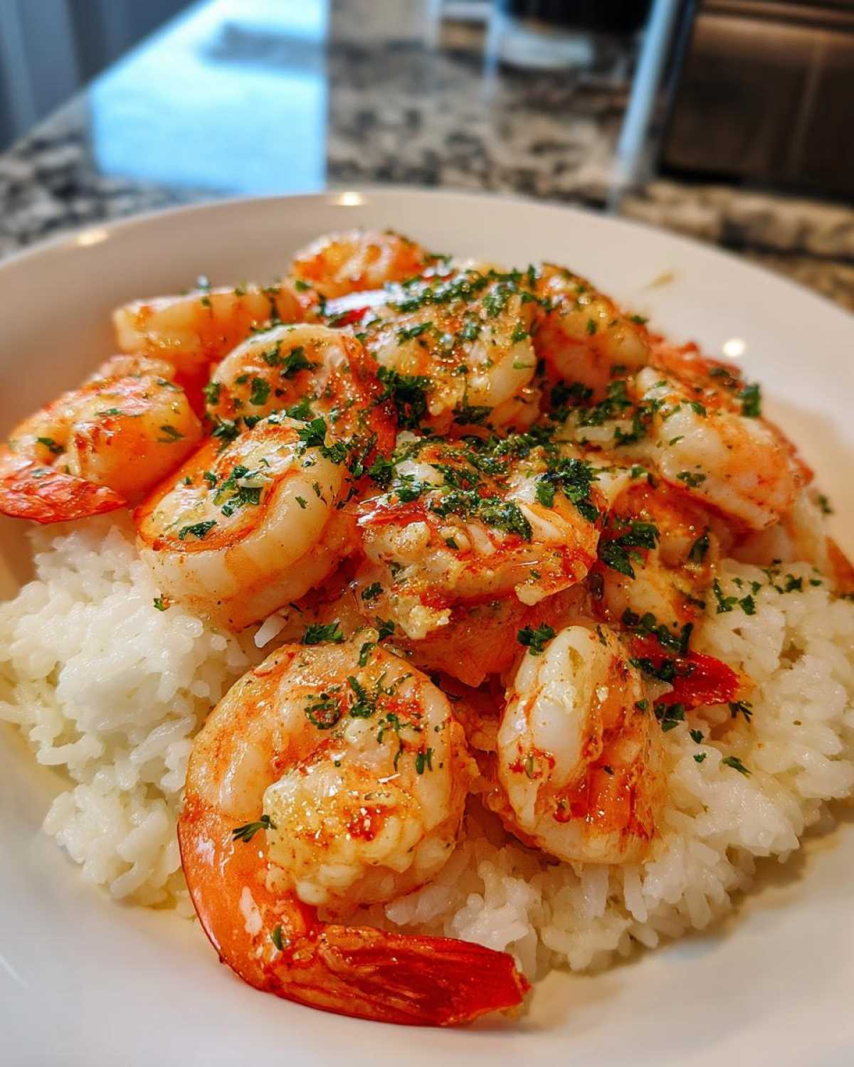 Close-up of juicy Garlic Butter Shrimp and Rice Skillet, topped with fresh parsley.