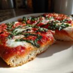 Close-up of thick-crust Gluten-Free Margherita Pizza slices topped with bright red sauce, melted mozzarella, and fresh basil.