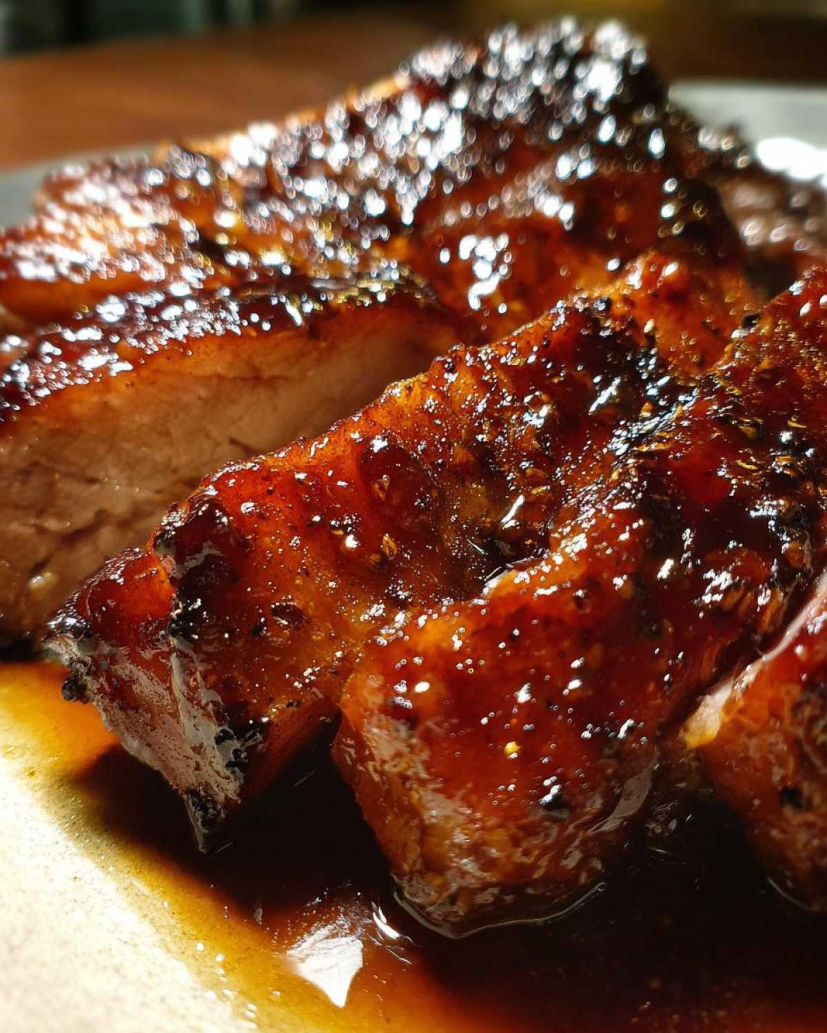 Close-up of thick-cut Honey Glazed Ham Steak slices covered in a shiny, dark amber glaze.