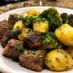 Close-up of juicy, seared steak bites mixed with roasted potatoes and broccoli from the One-Pan Garlic Butter Steak Bites and Potatoes.