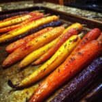 Close-up of vibrant Sheet Pan Roasted Rainbow Carrots with Honey glistening on a baking sheet.
