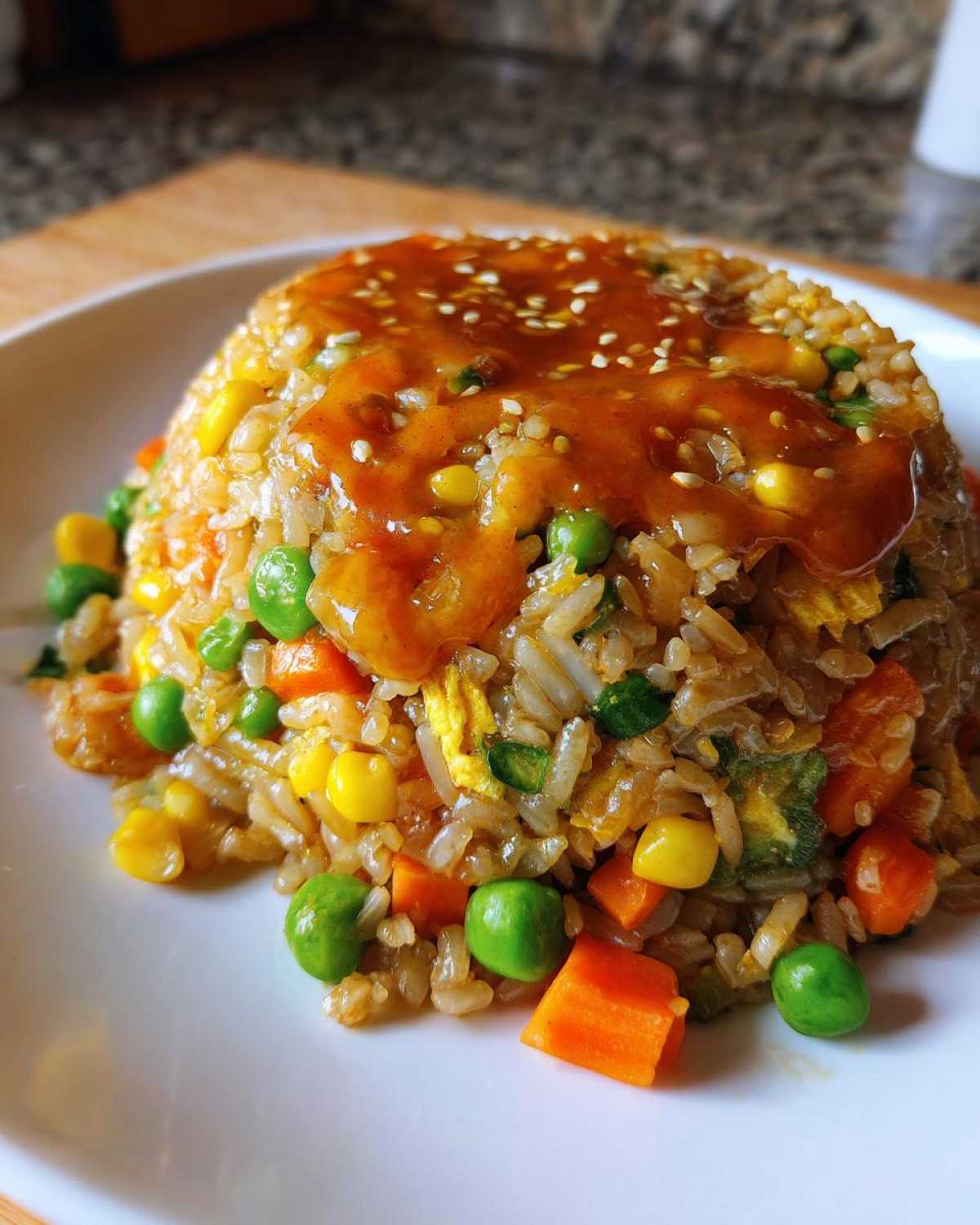 Mound of Vegetable Fried Rice topped with rich Sesame Ginger Sauce and sesame seeds.