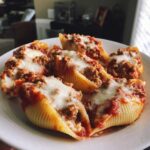 Close-up of baked Cheesy Ground Beef Stuffed Shells Easy Bake topped with melted mozzarella cheese and marinara sauce.