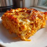 A square serving of Creamy Cajun Chicken Alfredo Bake with a golden, cheesy, baked top.