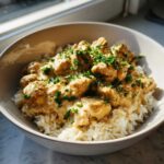 A bowl of Creamy Cajun Chicken Skillet with Rice, topped generously with fresh chopped parsley.