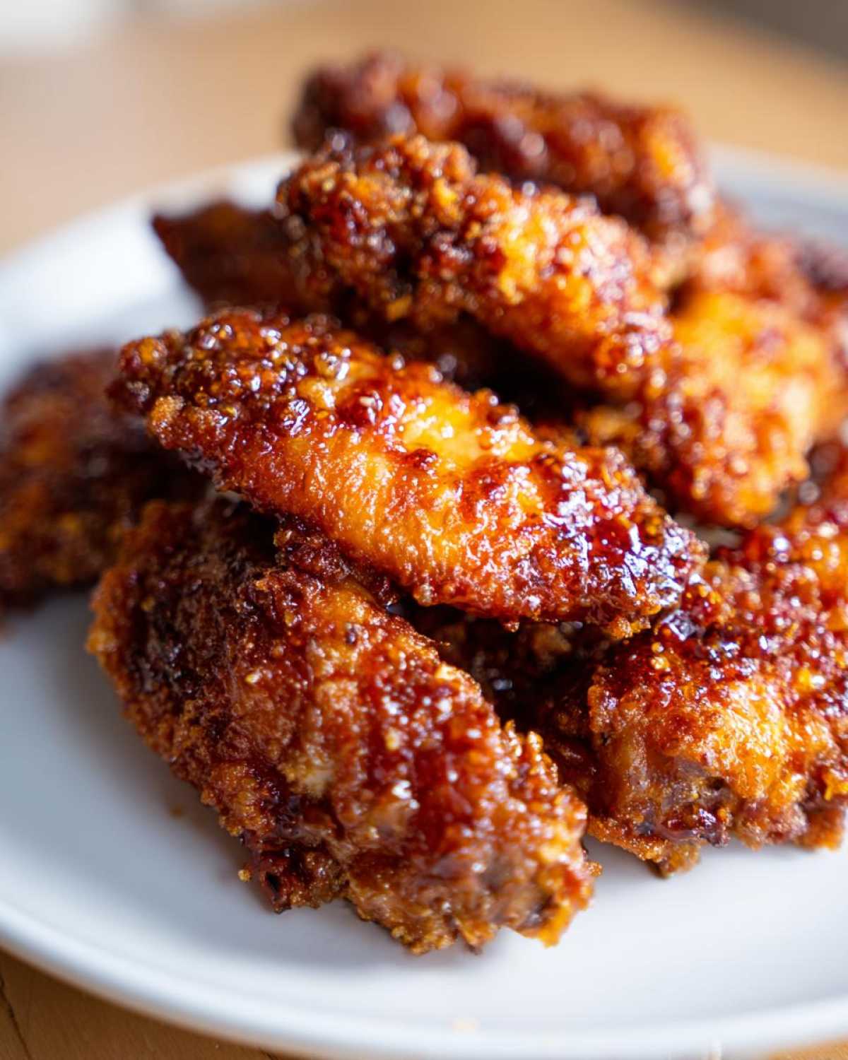Close-up of crispy oven baked Honey Garlic Chicken Wings coated in a sticky, caramelized glaze.