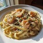 A close-up of Garlic Butter Shrimp Pasta with Cream Sauce, featuring fettuccine, plump shrimp, and parsley.