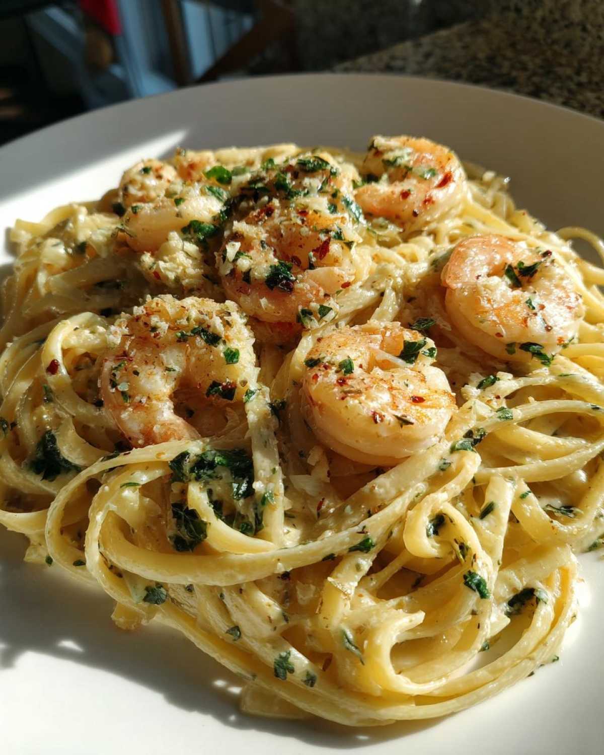 A close-up shot of creamy Garlic Butter Shrimp Pasta with linguine, topped with seasoned shrimp and fresh parsley.