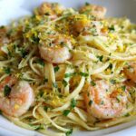 Close-up of Garlic Butter Shrimp Pasta with lemon zest and fresh parsley garnish.