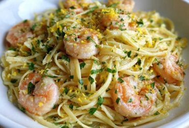 Close-up of Garlic Butter Shrimp Pasta with lemon zest and fresh parsley garnish.