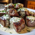 Close-up of seared Garlic Butter Steak Bites generously covered in a creamy garlic sauce and sprinkled with parsley.