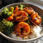 Close-up of a Honey Soy Shrimp Bowl with rice, glazed shrimp, and steamed broccoli and carrots.