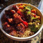 Close-up of a Sticky BBQ Chicken Bowl featuring glazed chicken pieces, roasted broccoli, and brown rice.