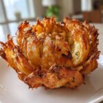 A perfectly cooked Air Fryer Crispy Mini Blooming Onions Golden Fun served on a white plate.