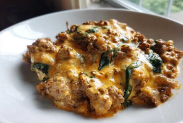 A close-up of a creamy, cheesy ground beef and spinach casserole, perfect for Easy Keto Meals for Weight Loss.