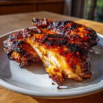 Close-up of perfectly cooked Vietnamese Grilled Chicken pieces showing a moist interior and a dark, caramelized glaze.