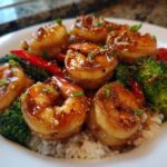 Close-up of Honey Garlic Shrimp Bowls featuring glazed shrimp, bright green broccoli, and red pepper slices over white rice.