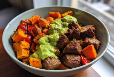 Close-up of Steak and Sweet Potato Bowls topped with a bright green Avocado-Cilantro Drizzle.
