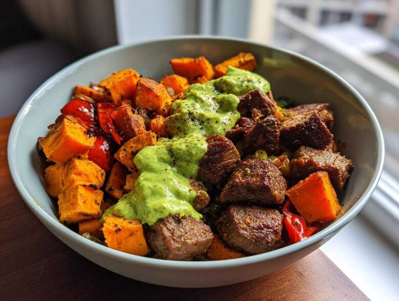 Close-up of Steak and Sweet Potato Bowls topped with a bright green Avocado-Cilantro Drizzle.